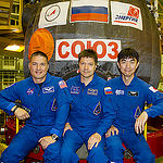 In the Integration Facility at the Baikonur Cosmodrome in Kazakhstan, Expedition 44 crew members Kjell Lindgren of NASA (left), Oleg Kononenko of the Russian Federal Space Agency (Roscosmos, center) and Kimiya Yui of the Japan Aerospace Exploration Agency (right) pose for pictures in front of their Soyuz TMA-17M spacecraft July 11 during a fit check dress rehearsal session. The trio will launch July 23, Kazakh time from Baikonur for a five-month mission on the International Space Station. Credit: Gagarin Cosmonaut Training Center. 