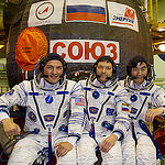 In the Integration Facility at the Baikonur Cosmodrome in Kazakhstan, Expedition 44 crewmembers Kjell Lindgren of NASA (left), Oleg Kononenko of the Russian Federal Space Agency (Roscosmos, center) and Kimiya Yui of the Japan Aerospace Exploration Agency (right) pose for pictures in front of their Soyuz TMA-17M spacecraft July 11 during a fit check dress rehearsal session. The trio will launch July 23, Kazakh time from Baikonur for a five-month mission on the International Space Station. Credit: Gagarin Cosmonaut Training Center. 