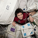 ISS043E159309 (05/04/2015) --- ESA (European Space Agency) astronaut Samantha Cristoforetti glides through supply containers packed onboard the International Space Station.