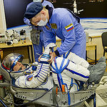 In the Integration Facility at the Baikonur Cosmodrome in Kazakhstan, Expedition 44 crew member Kjell Lindgren of NASA undergoes a pressure and leak check of his Sokol launch and entry suit July 11 as part of a fit check dress rehearsal. Lindgren, Oleg Kononenko of the Russian Federal Space Agency (Roscosmos) and Kimiya Yui of the Japan Aerospace Exploration Agency will launch July 23, Kazakh time from Baikonur in their Soyuz TMA-17M spacecraft for a five-month mission on the International Space Station. Credit: Gagarin Cosmonaut Training Center