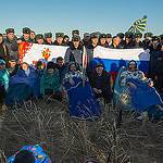 Expedition 37 Crew Members Sit Outside the Soyuz Capsule